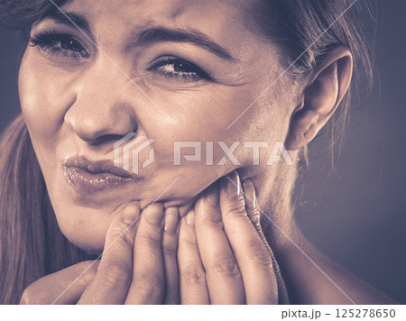 Woman suffering from tooth pain 125278650