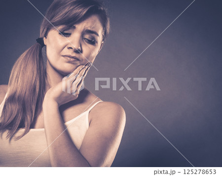 Woman suffering from tooth pain 125278653