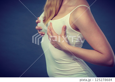 Woman holding hands on her breast Woman holding hands on her breast 125278684