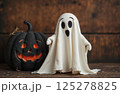 portrait of a cute little ghost in autumn decoration, Halloween holiday theme 125278825