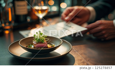 Elegant dining experience with gourmet dish and menu at upscale restaurant in the evening 125278857
