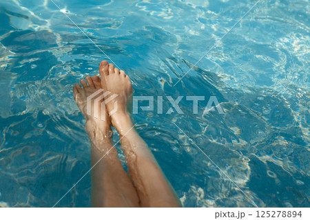 A girl's feet in a blue pool. Epilation of legs, varicose veins. Rest, relaxation on the beach, at the hotel. A woman in freedom. Vacation. High quality photo A girl's feet in a blue pool. Epilation of legs, varicose veins. Rest, relaxation on the beach, at the hotel. A woman in freedom. Vacation. High quality photo 125278894