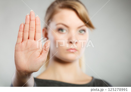 Assertive woman making stop gesture. 125278991