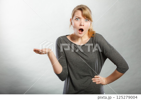 Surprised astonished girl with open mouth. Surprised astonished girl with open mouth. 125279004