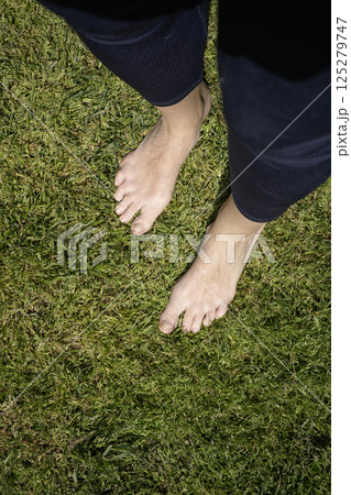 Naked female feets on the lawn Naked female feets on the lawn 125279747