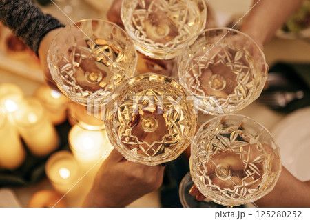 Close-up of male and female hands with elegant champagne glasses Close-up of male and female hands with elegant champagne glasses 125280252