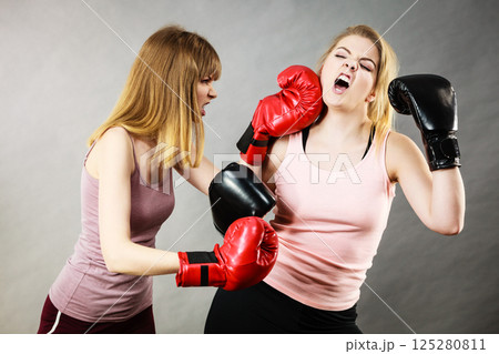 Two agressive women having boxing fight Two agressive women having boxing fight 125280811