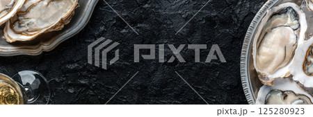 Fresh raw oysters on ice panorama, overhead flat lay shot 125280923