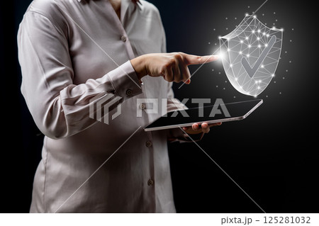 Businessperson holding tablet while touching wireframe protection shield icon. Technology innovation on a virtual screen. Concept of Business Financial Warranty and Guarantee Insurance Businessperson holding tablet while touching wireframe protection shield icon. Technology innovation on a virtual screen. Concept of Business Financial Warranty and Guarantee Insurance 125281032