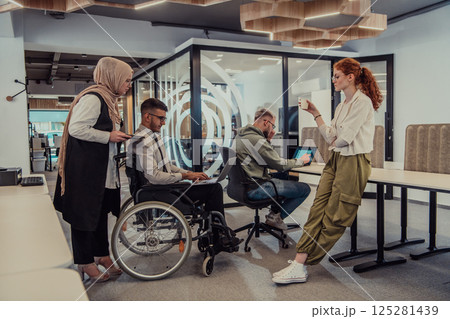 Young group of business people brainstorming together in a startup space, discussing business projects, investments, and solving challenges. Young group of business people brainstorming together in a startup space, discussing business projects, investments, and solving challenges. 125281439
