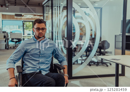 In a large modern corporation, a determined businessman in a wheelchair navigates through a hallway, embodying empowerment and inclusivity in the corporate world. In a large modern corporation, a determined businessman in a wheelchair navigates through a hallway, embodying empowerment and inclusivity in the corporate world. 125281459