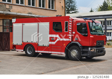 A state-of-the-art firetruck, equipped with advanced rescue technology, stands ready with its skilled firefighting team, prepared to intervene and respond rapidly to emergencies, ensuring the safety 125281480