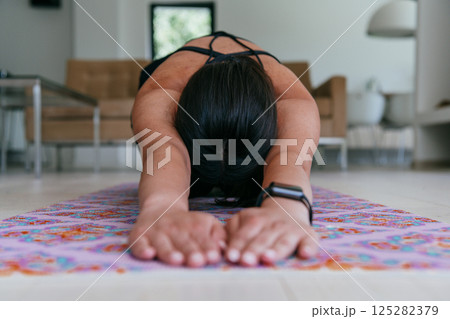Young Beautiful Female Exercising, Stretching and Practising Yoga with Trainer via Video Call Conference in Bright Sunny House. Healthy Lifestyle, Wellbeing and Mindfulness Concept Young Beautiful Female Exercising, Stretching and Practising Yoga with Trainer via Video Call Conference in Bright Sunny House. Healthy Lifestyle, Wellbeing and Mindfulness Concept 125282379