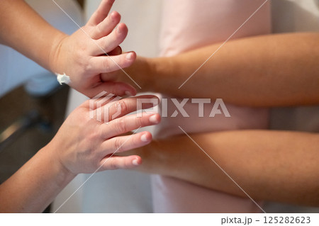 Foot Massage Therapy in a Relaxing Spa Setting. A professional massage therapist in a white uniform provides a soothing foot massage to a client in a calm and serene spa environment 125282623