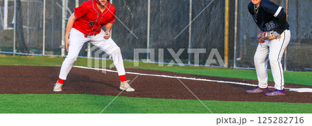 High School Baseball Player Leading off of First Base During a Game 125282716