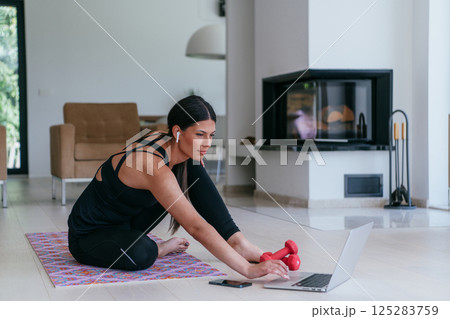 Young Beautiful Female Woman with Trainer via Video Call Conference in Bright Sunny House. Healthy Lifestyle, Wellbeing and Mindfulness Concept 125283759