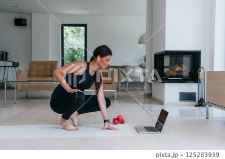 Young Beautiful Female Woman with Trainer via Video Call Conference in Bright Sunny House. Healthy Lifestyle, Wellbeing and Mindfulness Concept 125283939