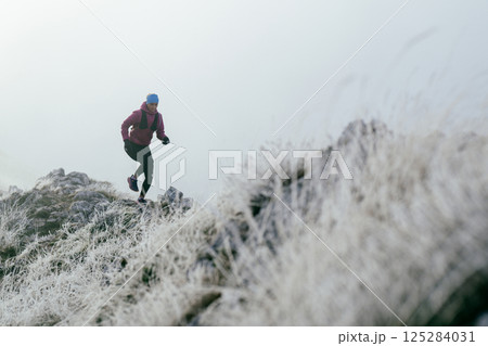 Trail Runner in Misty Mountain Landscape Trail Runner in Misty Mountain Landscape 125284031