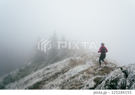 Trail Runner in Misty Mountain Landscape 125284155