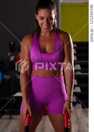 Fit Woman Performing Rope Conditioning Exercise in the Gym Fit Woman Performing Rope Conditioning Exercise in the Gym 125284196