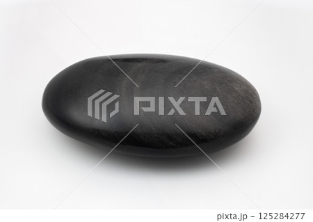Polished snow obsidian pebble with swirling grey patterns on a white background Polished snow obsidian pebble with swirling grey patterns on a white background 125284277