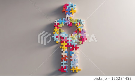 A figure of a man consisting of multicolored puzzles, he is missing an element in place of a heart 125284452