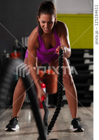 Fit Woman Performing Rope Conditioning Exercise in the Gym Fit Woman Performing Rope Conditioning Exercise in the Gym 125284611