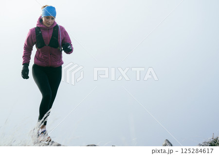 Trail Runner in Misty Mountain Landscape 125284617