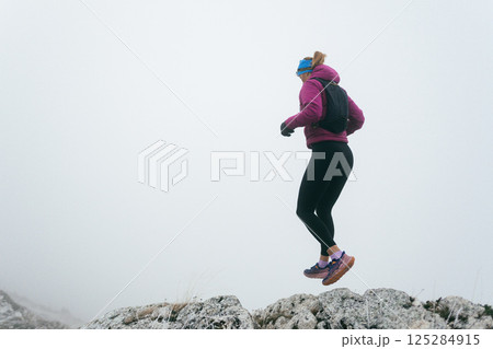 Trail Runner in Misty Mountain Landscape Trail Runner in Misty Mountain Landscape 125284915