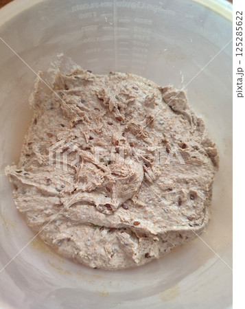 freshly mixed sourdough dough with starter ready for fermentation in a plastic bowl freshly mixed sourdough dough with starter ready for fermentation in a plastic bowl 125285622