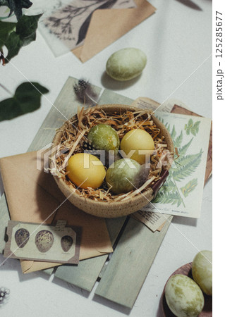Close up of colorful Easter eggs in a basket, and decorations on the background, vintage style 125285677