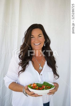 Touch of feminine hands brings together a symphony of colors and tastes, a perfect salad composition. A flavorful and wholesome salad, a symphony of health. Touch of feminine hands brings together a symphony of colors and tastes, a perfect salad composition. A flavorful and wholesome salad, a symphony of health. 125286725