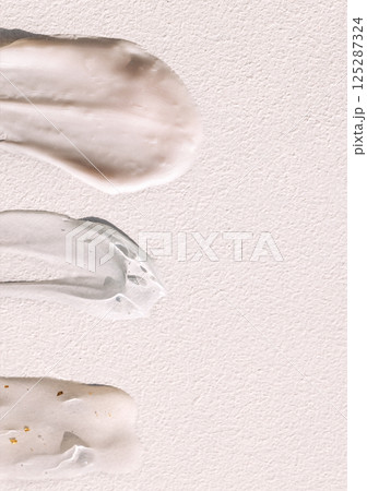Different texture of gel and cream on a light background. Transparent serum with bubbles and colloidal gold. The consistency of glycerin gel. Various cosmetic cream smears. Different texture of gel and cream on a light background. Transparent serum with bubbles and colloidal gold. The consistency of glycerin gel. Various cosmetic cream smears. 125287324
