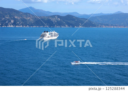 Tourist cruise liner in bay of Porto Venere, Liguria. Sea and holidays in Italy. Background for design. Tourist cruise liner in bay of Porto Venere, Liguria. Sea and holidays in Italy. Background for design. 125288344