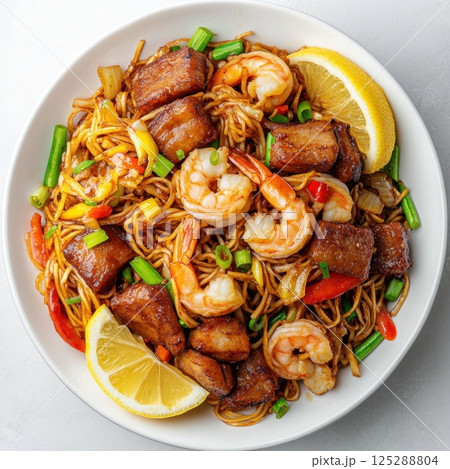 Labor Day in the Philippines (May 1) Delicious shrimp and pork stir-fry noodles with vegetables in a white bowl 125288804