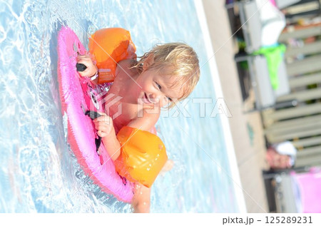 Child Enjoying Pool with Float and Water Wings 125289231