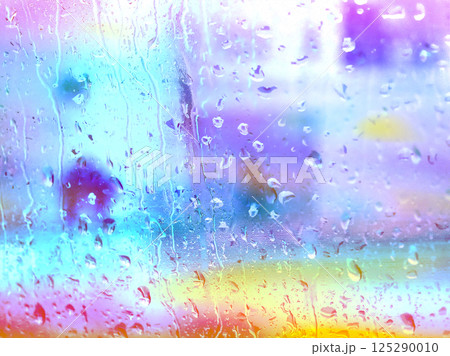 Colourful rainy window with raindrops in rainy day. Abstract drops flowing down on a window surface. Textured wallpaper. Wet glass in a stormy weather 125290010