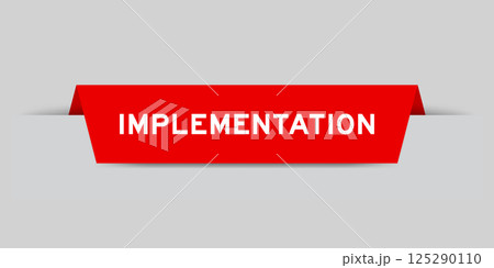 Red color inserted label with word implementation on gray background 125290110