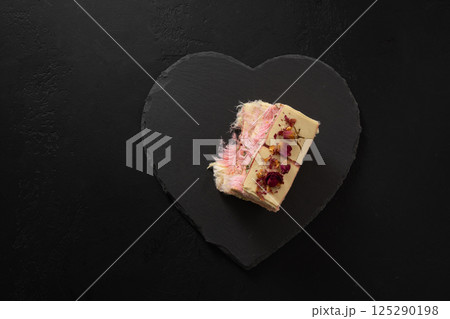 Trendy pink chocolate with airy filling on black board. Tasty dessert. Trendy pink chocolate with airy filling on black board. Tasty dessert. 125290198