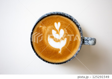 Close up shot of hot coffee latte art on wood table in cafe Close up shot of hot coffee latte art on wood table in cafe 125291549