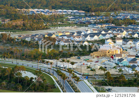 Wooden houses under construction in new developing suburban area. Development of residential housing in American suburbs. Real estate market in the USA Wooden houses under construction in new developing suburban area. Development of residential housing in American suburbs. Real estate market in the USA 125291726