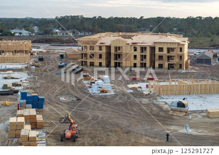 Wooden apartment buildings under construction in new developing suburban area. Development of residential housing in Florida suburbs. Real estate market in the USA 125291727