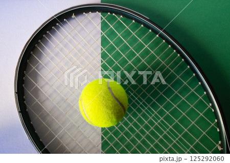 Raket and tennis ball on white and green background. Concept of sports competitions 125292060