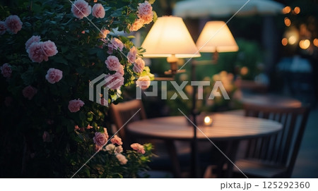 Outdoor garden cafe at summer evening. Wooden tables 125292360