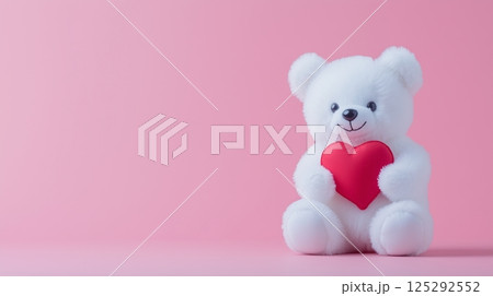 White Teddy Bear Holding Red Heart on Pink Background 125292552