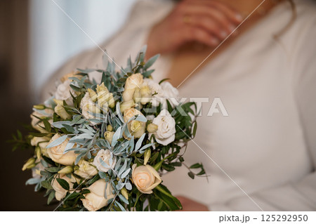 Elegant Bridal Bouquet with Soft Pastel Flowers and Lush Greenery 125292950