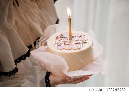 Birthday Cake Celebration with Candle and Decorative Topper 125292983