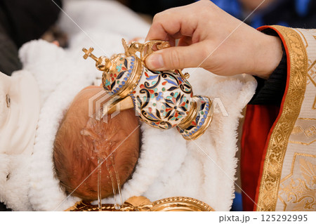 A Traditional Baptism Ceremony with a Decorated Font and a Newborn Being Blessed A Traditional Baptism Ceremony with a Decorated Font and a Newborn Being Blessed 125292995