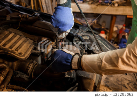 Car Maintenance Technician Working Under the Hood 125293062