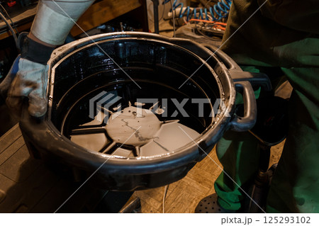 Industrial Oil Collection in Workshop Setting 125293102